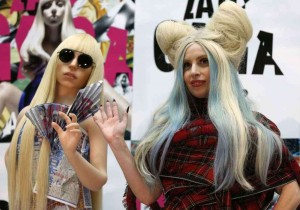 Singer Lady Gaga poses with a Gagadoll during a news conference to promote her latest album "Artpop" in Tokyo