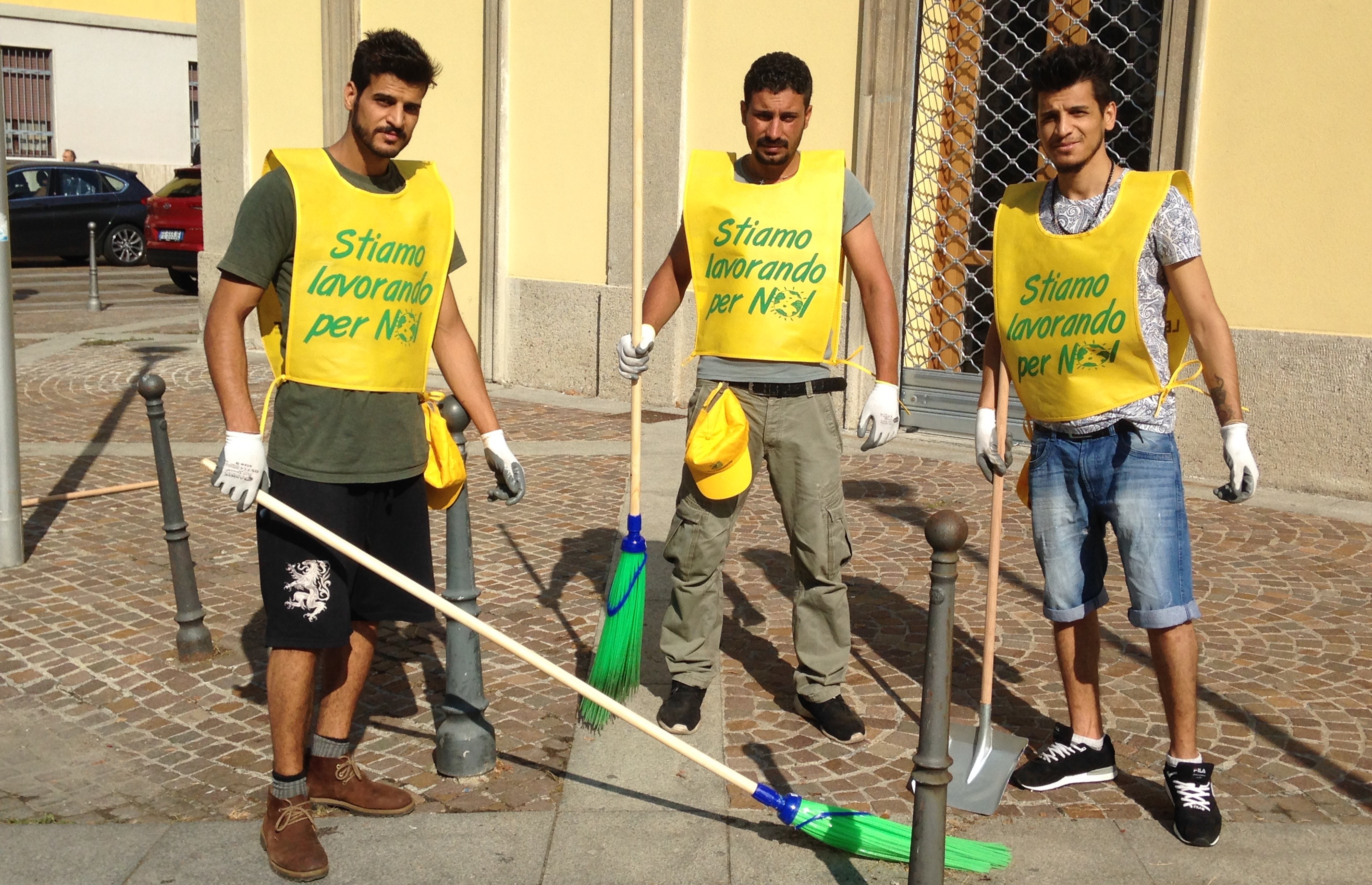 Tre migranti di origini irachene, tra i 350 volontari che si sono offerti per pulire le strade di Milano 
